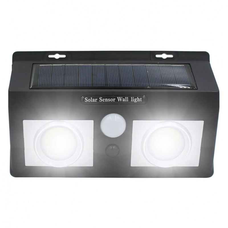 Lampara solar LED para exterior con sensor de movimiento. Foco de pared con panel solar. Luz blanca para jardines o patios.